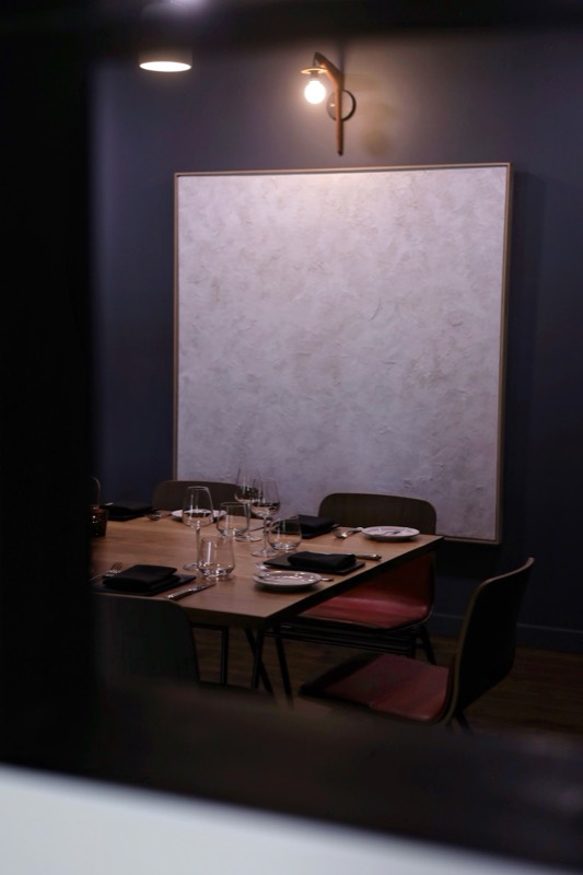 A Julie Brayton painting installed — private dining room