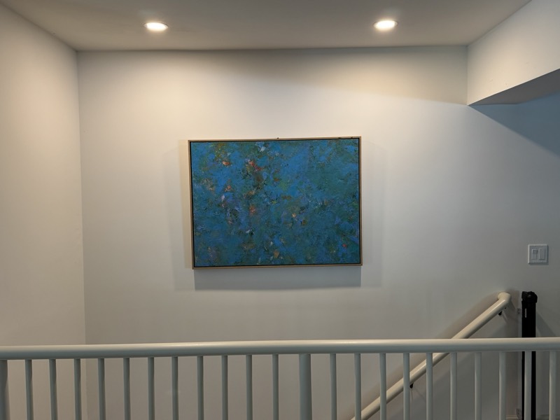 A Julie Brayton painting installed — stair landing, private residence